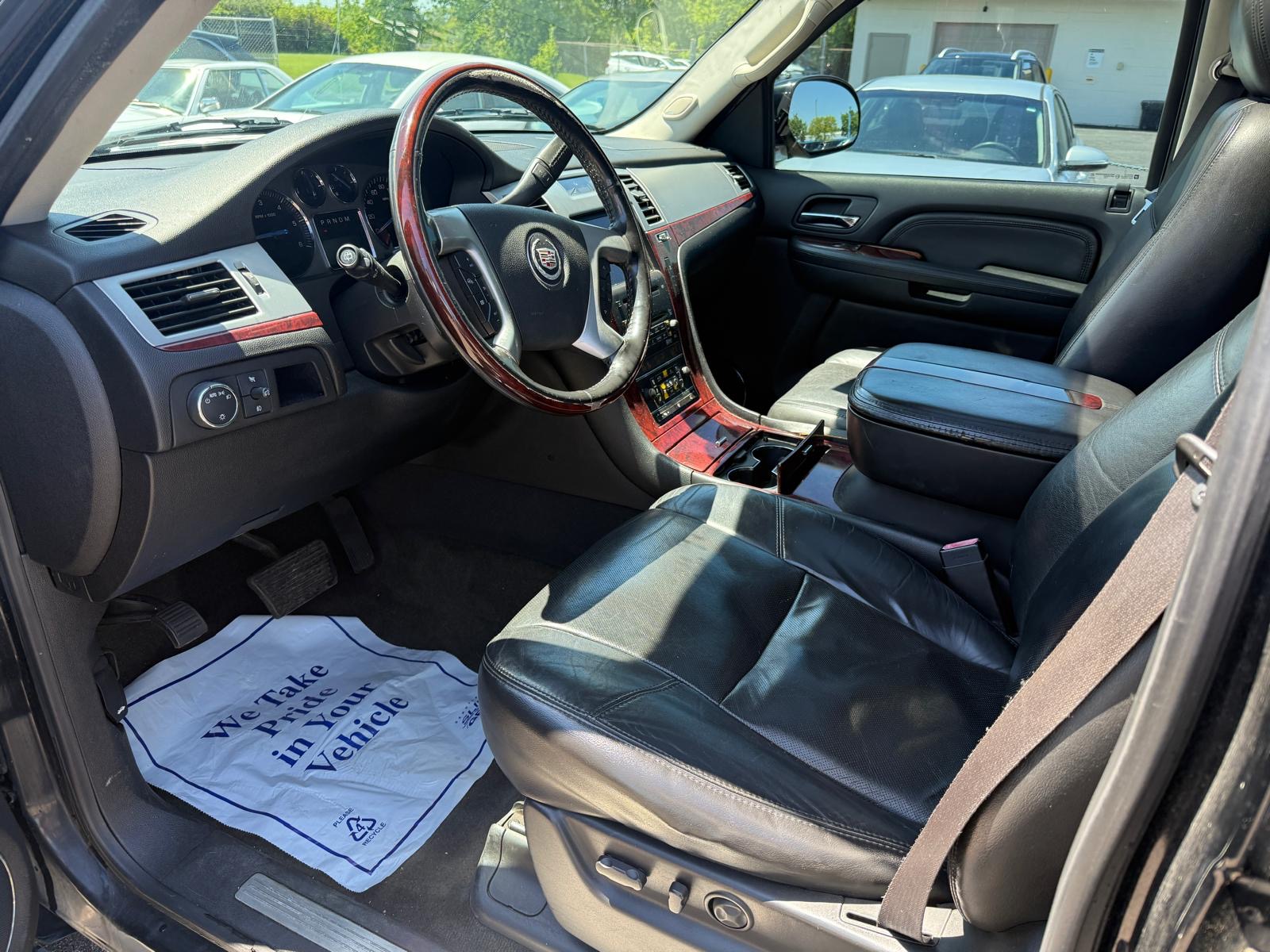 Cadillac Escalade black leather interior with wood trim detailed